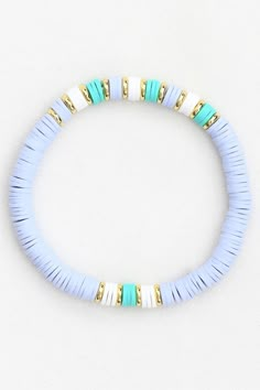 a blue and white beaded bracelet with gold accents