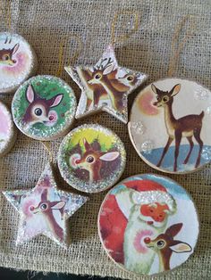 six christmas ornaments are hanging on a burlockse tablecloth with reindeers and snowflakes