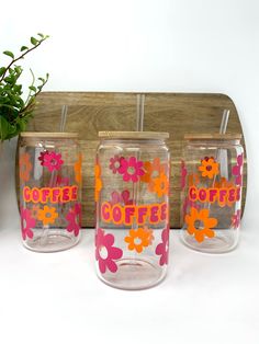 three coffee mugs with flowers painted on them