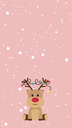 a pink background with a reindeer sitting in the snow