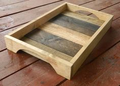 a wooden tray sitting on top of a wooden floor