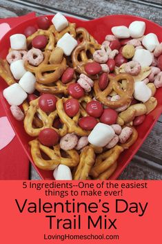 valentine's day trail mix in a heart shaped bowl with marshmallows and pretzels