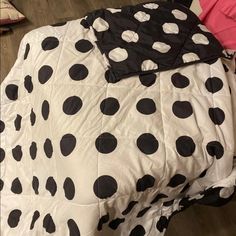 a bed with black and white polka dots on it