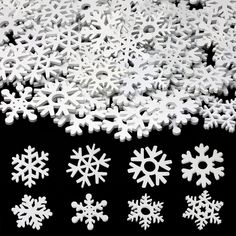 white snowflakes are arranged in rows on a black background, including one for the center