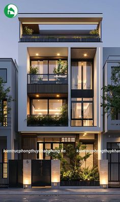 an apartment building with many balconies and plants on the balconys at night