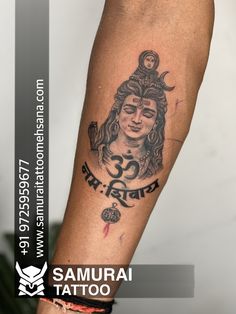 the tattoo on the arm has an image of hindu god and is in red ink