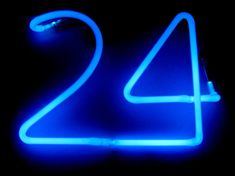 a neon sign with the number twenty four on it