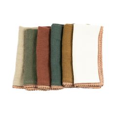 four different colored napkins on top of each other