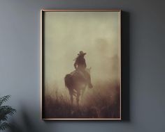 a man riding on the back of a horse in a foggy field with tall grass