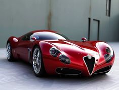 a red sports car sitting on top of a white floor