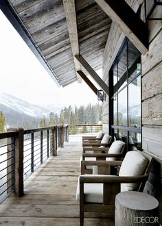 a long wooden porch with chairs on it