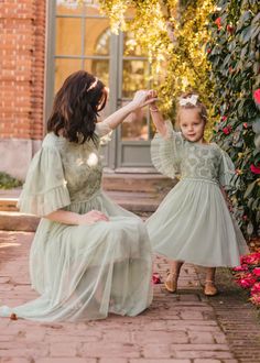 a mother and her daughter in matching dresses