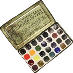 an open box of watercolor paints on a white background