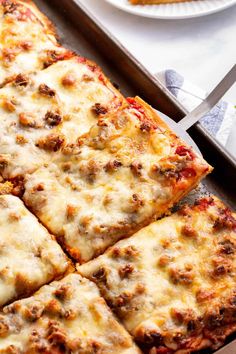 a pizza sitting on top of a pan covered in cheese