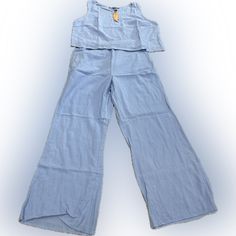 Women’s 2pc Pants Suite. Wide Legs. Sleeveless. Light Blue. Large. Spring Cotton Pant Set With Pockets, Casual Pant Set For Spring Day Out, Casual Pant Set For Day Out, Casual Light Blue Sets With Pockets, Casual Spring Matching Pant Set, Casual Spring Pant Set, Casual Wide Leg Sets For Day Out, Casual Wide Leg Two-piece Bottoms Set, Casual Two-piece Set With Wide Leg Bottoms