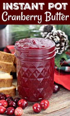 cranberry butter in a jar next to sliced bread and fresh cranberries