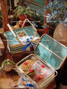 two baskets filled with food sitting on top of a table