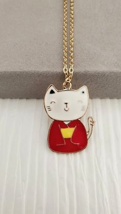 Japanese Cat Necklace  This Animal Pendant is a great piece of jewelry to add to your collection or gift to that special someone in your life. Pendant: ~ Japanese Metal Cat ~ Enamel Over Gold Plating ~ Size: 26mmx35mm Chain Type: ~ Gold Plated Oval Chain (Choose Your Chain Length During Checkout) 👉 Link to Our STOREFRONT: https://www.etsy.com/shop/FashionCrashJewelry?ref=shopsection_shophome_leftnav&ga_search_query=crystal%2Bnecklace Our Motto ~ Happy Customers Are Awesome 🌞Let us know of any Valentine's Day Gift Cat Design Necklace, Cat Design Pendant Jewelry, Elegant Cat Design Pendant Necklace, Silver Cat Design Pendant Charm Necklace, Japanese Cat, Cat Pendants, Cat Necklace, White Cat, Animal Jewelry