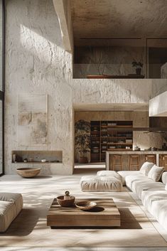 a living room filled with white furniture and lots of natural light coming in from the windows