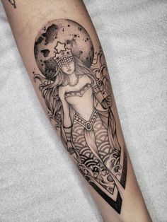 a woman's arm with a tattoo on it and an arrow in the middle