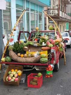 a red truck filled with lots of fruits and vegetables