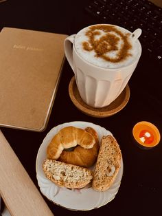 a cup of coffee and some bread on a table