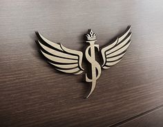 a medical symbol with wings and a crown on it's head is shown in this image