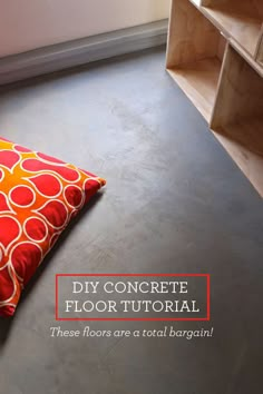 a red and yellow pillow sitting on top of a floor