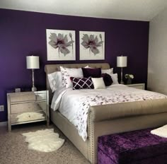 a bedroom with purple walls and white furniture