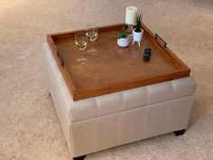 a coffee table with two wine glasses on it