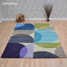 a rug on the floor with a dog sitting next to it and a wallpapered background