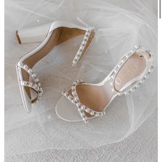 the bride's shoes and veil are laying on the floor