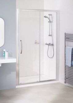 a bathroom with a sink, mirror and shower stall in it's corner area