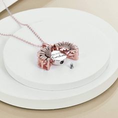 a white plate topped with a pink bow necklace and two matching earrings on top of it