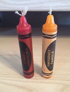 two crayons sitting on top of a wooden table