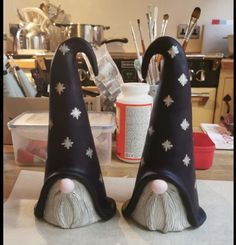 two black gnome hats sitting on top of a counter