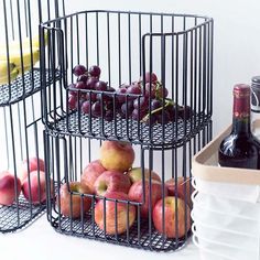 three black wire baskets filled with fruit and wine