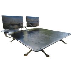 two chairs sitting on top of a metal table