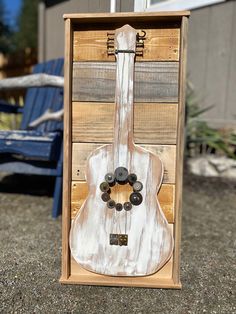 a wooden box with a guitar on it