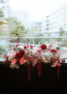 flowers are arranged on the window sill