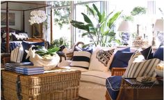 a living room filled with lots of furniture and decor on top of a hard wood floor