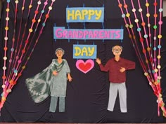 two people standing next to each other in front of a sign that says happy grandparents day