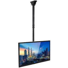 a flat screen tv mounted to the side of a pole with a cityscape in the background