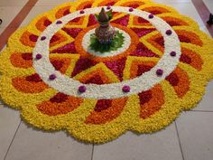 a large flower arrangement on the ground in front of a man walking down the street