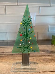 a glass christmas tree on a counter top