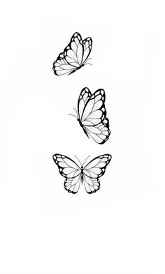 three butterflies flying in the air with one on its back and another on its side