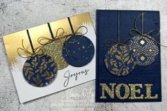 two cards with gold and blue decorations on them, one has a tag that says noel