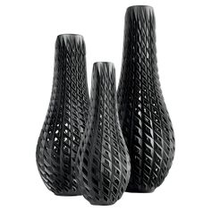 three black vases sitting next to each other