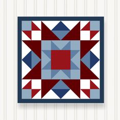 a red, white and blue quilt hanging on a wall