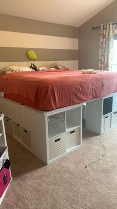 a bedroom with a bed, dressers and other items on the carpeted floor